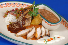chicken with red and black mole sauce served at hacienda del cuervo restaurant - cabo san lucas