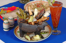 beef and chicken molcajete served at hacienda del cuervo restaurant - cabo san lucas